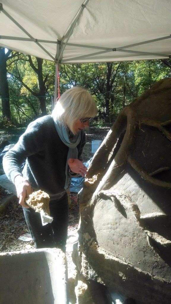 Elaine Ball is digging out the sand form.